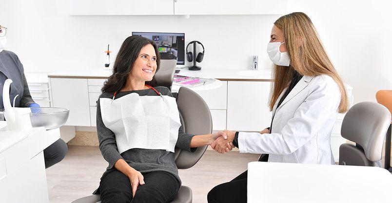 Happy patient pointing to smile