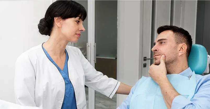 Happy patient pointing to smile